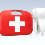 A white tooth floats next to a red and white first aid kit to indicate a dental emergency